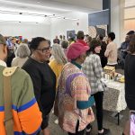 Crowd of people in an art gallery.