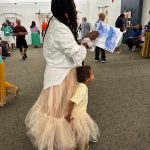 Tiffany Thomas and a small child in front of her
