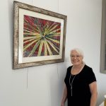 Jane Jackson standing in front of art on the wall