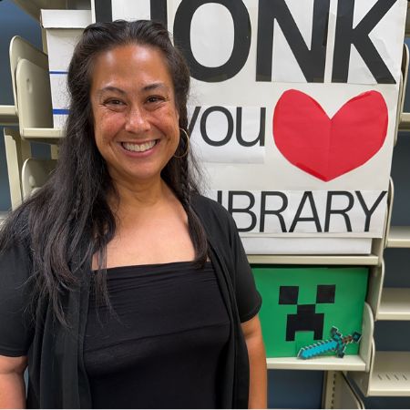 photo of kimberly in front of honk if you love the library sign