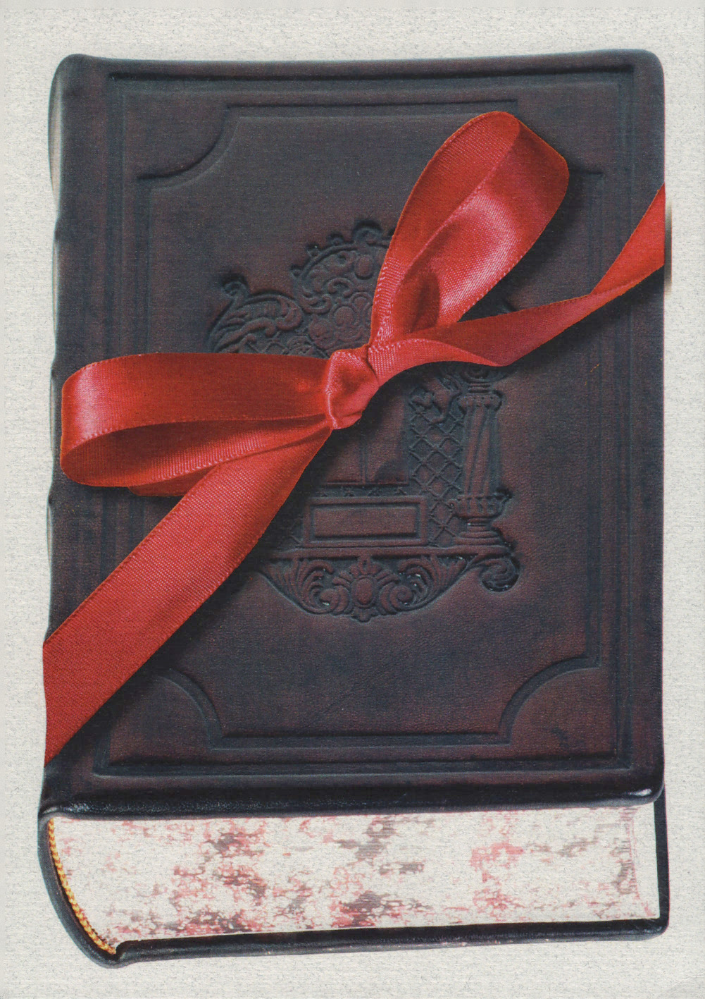 Front of invitation to ribbon cutting ceremony showing old book and red ribbon