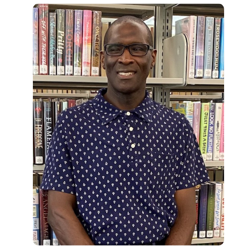 Michael standing in front of book shelves