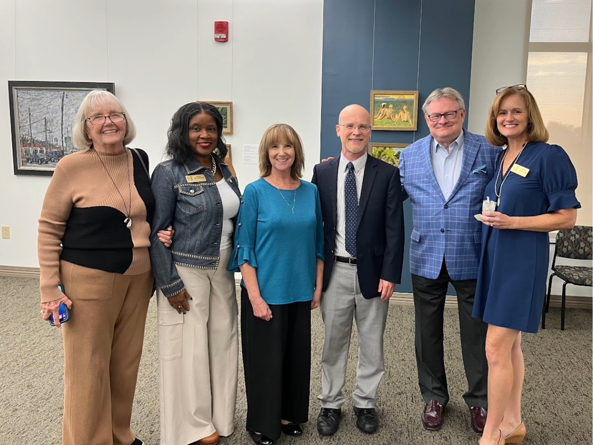 Donor Willson Powell standing with members of the Friends group and library director