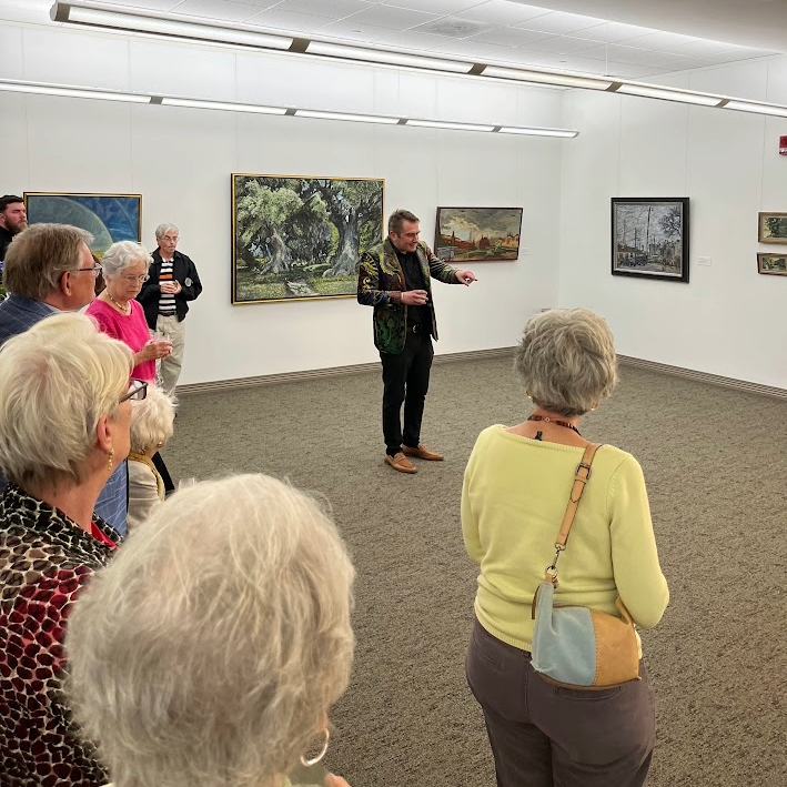Nikolai Oskolkov talking in front of gallery patrons