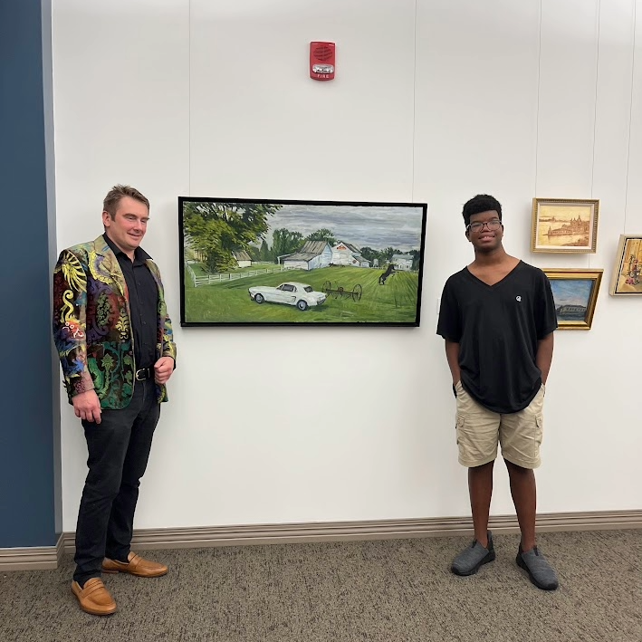 Nikolai Oskolkov standing with young man in front of car painting