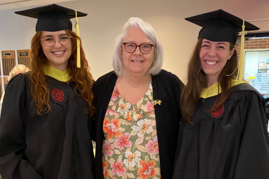 Paula with two smiling graduates