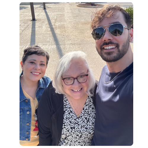 Two ladies and a man taking a selfie