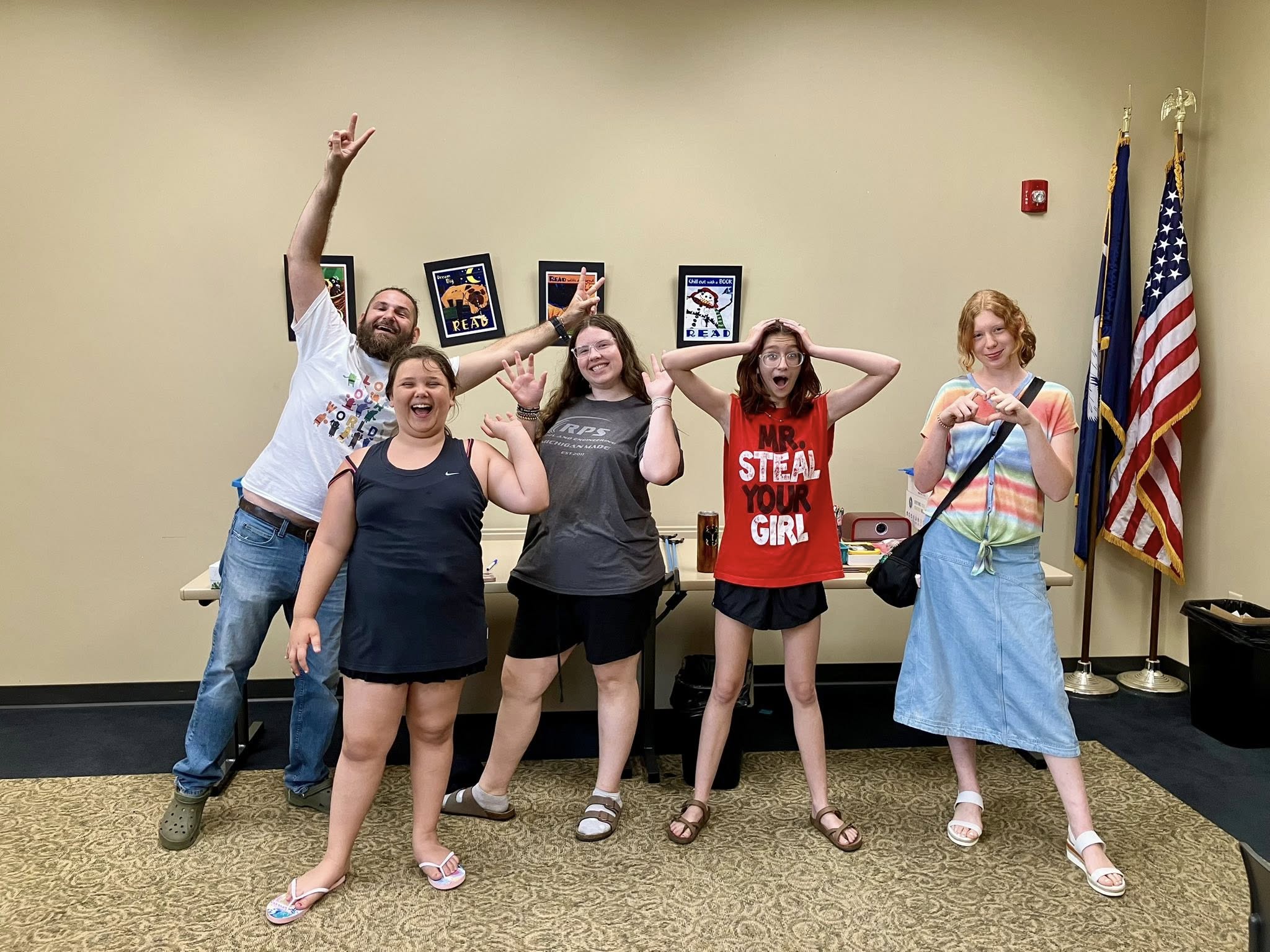 A group of people holding their hands up for a fun photo