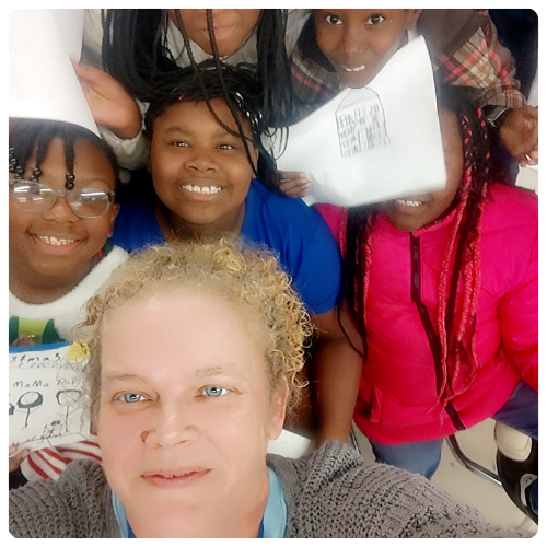 Penny surrounding by smiling children