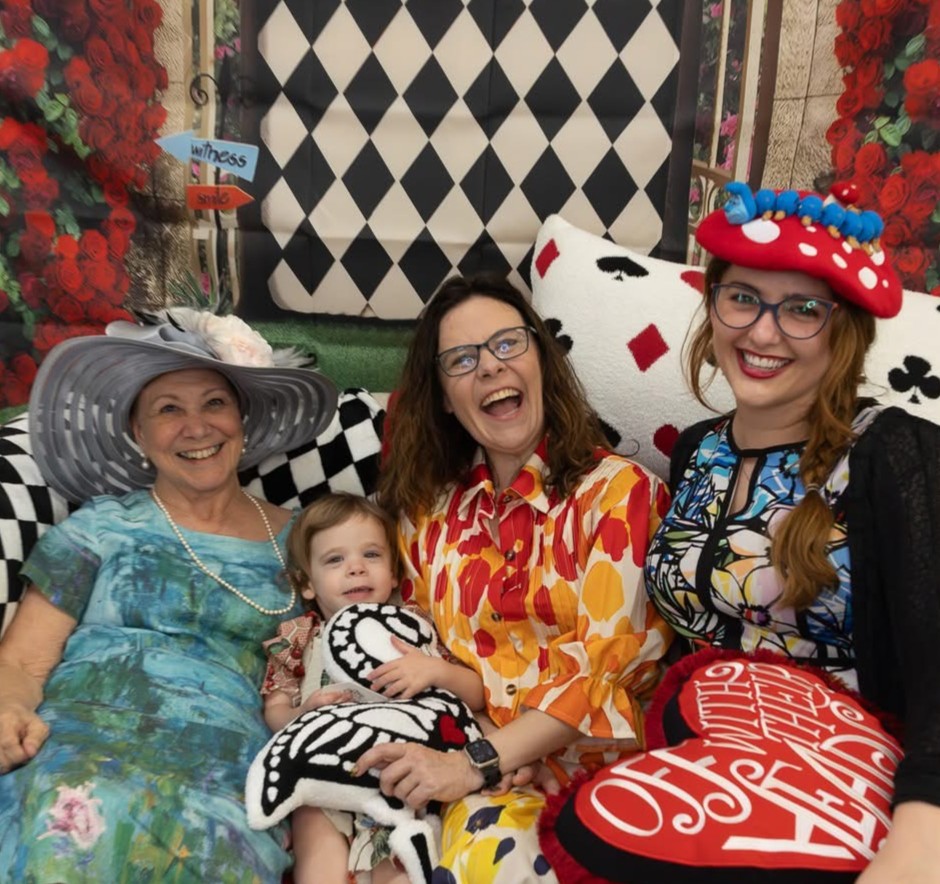 Mikaela and two ladies and one child at a tea party