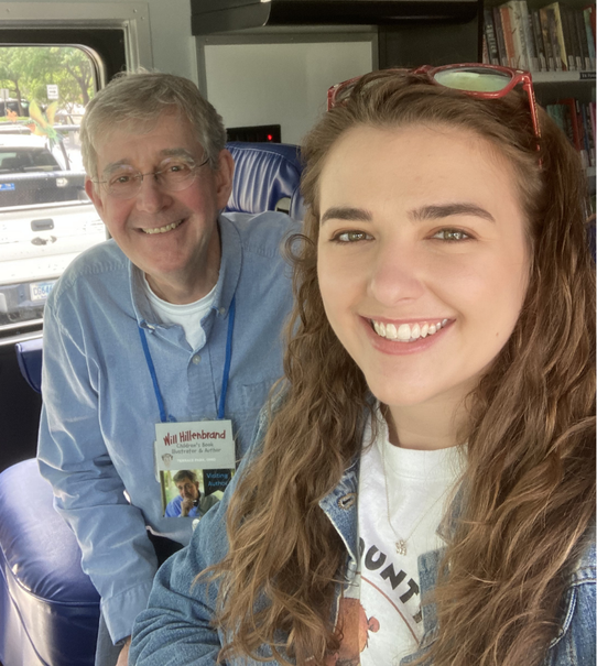 Mikaela and author Will Hillenbrand inside of the bookmobile