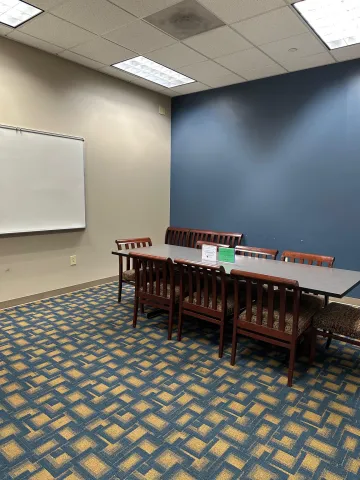 Image of study room 253, including table, chairs, and whiteboard.