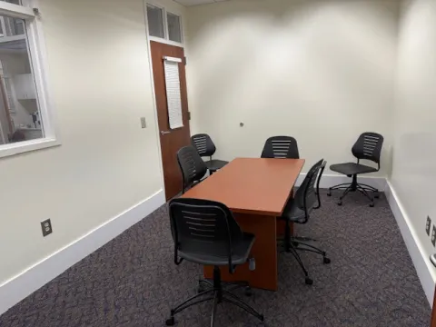 View of study room with table and chairs.