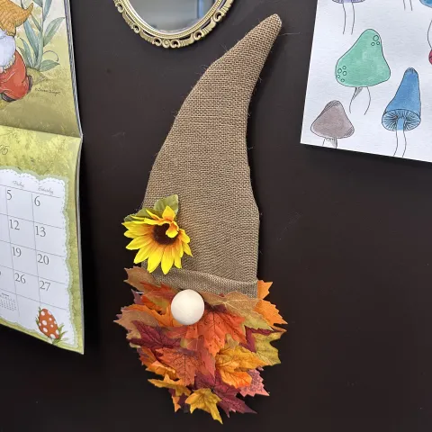 Gnome door hanger made with burlap, leaves, and a flower