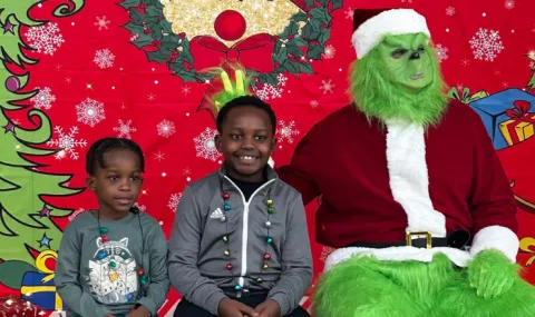 Boys sitting with the Grinch