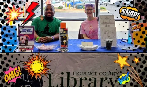 Comic book icons surrounding two people sitting at a table