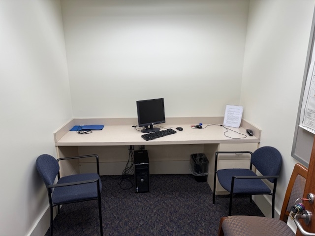 View of small study room with two chairs.