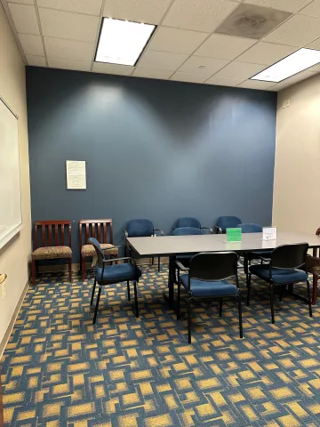 View from doorway of study room 252, showing whiteboard, table, and chairs.