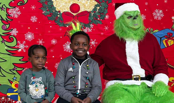 Boys sitting with the Grinch