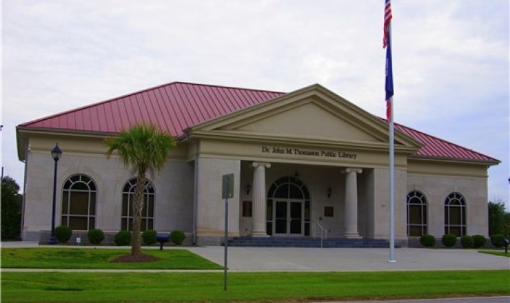 Front of Olanta Library with flag pole in front